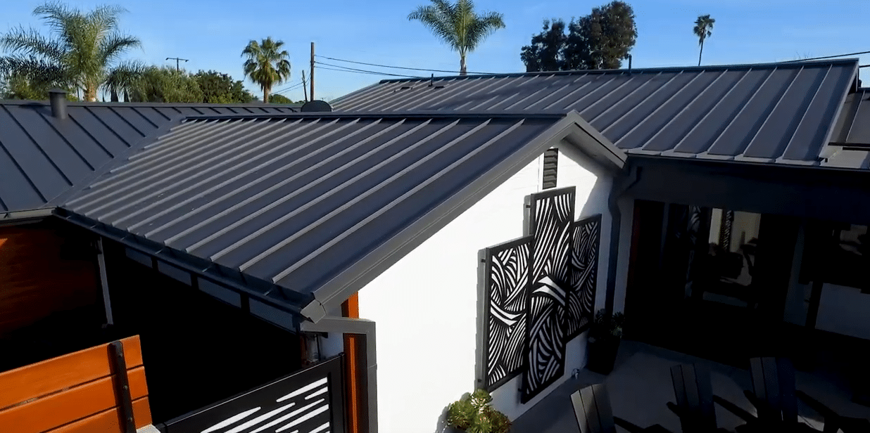 Black standing seam metal roof on a modern home. 