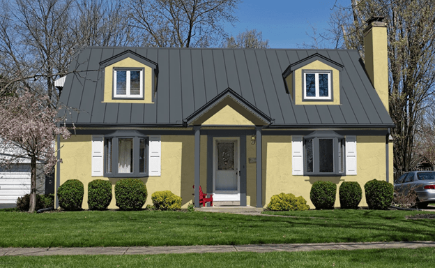 Dark gray metal roof on a yellow house